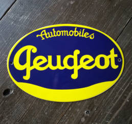 Plaque émaillée ovale avec un ancien logo de Peugeot en deux couleurs
